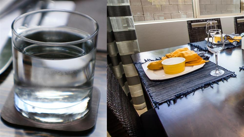 glass cup on coaster, wood table with place settings